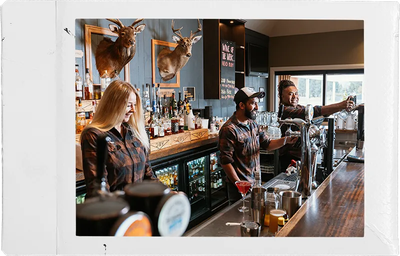 a man and a woman standing at a bar in five stags crowmell
